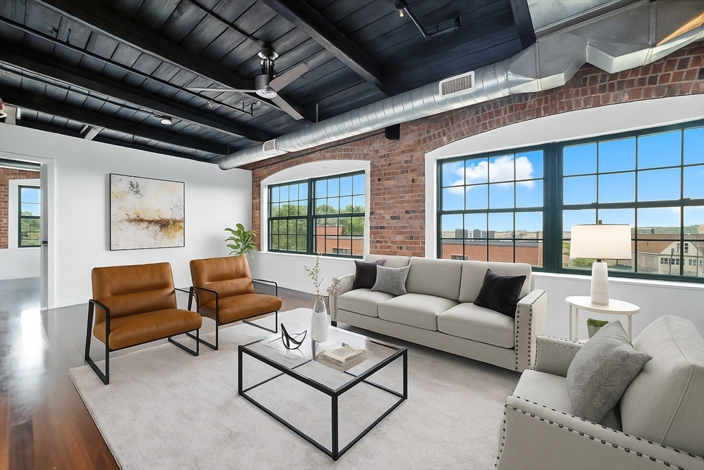 210 Broadway, Unit 406 Everett, MA 02149 - Photo 3 of 33 a living room with furniture and a large window