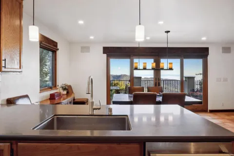 a kitchen with kitchen island a counter and a refrigerator