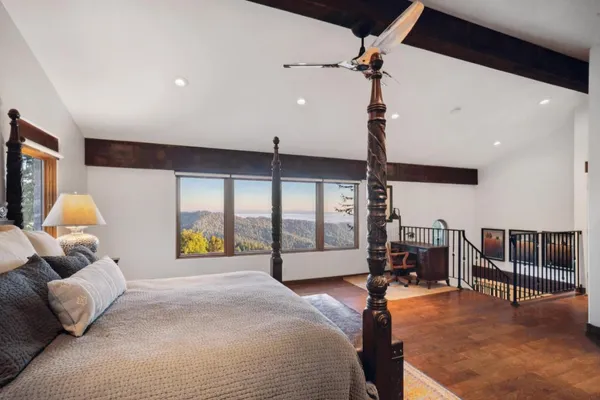 a bedroom with a bed couch and window