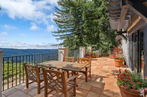 a view of a chairs and table in the balcony