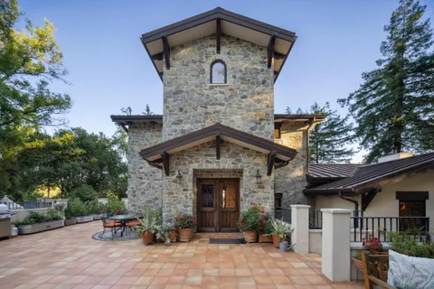 a front view of a house with a garden