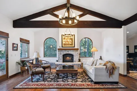 a living room with furniture a fireplace and a table