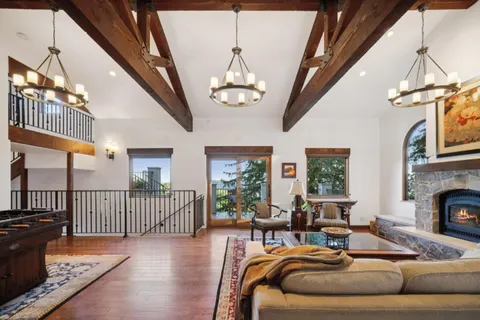 a living room with furniture chandelier and a rug