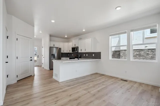 a view of kitchen with wooden floor