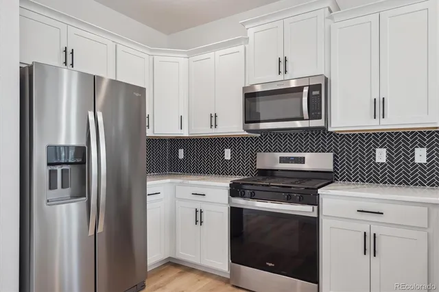 a kitchen with stainless steel appliances a refrigerator stove and microwave