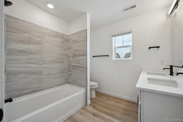 a bathroom with a sink a bathtub and a mirror