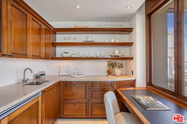 a kitchen with a sink a stove and cabinets