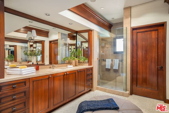 a spacious bathroom with a glass door shower and sink