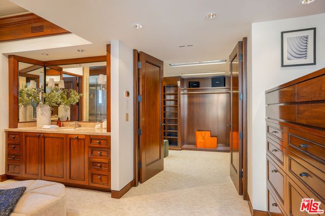 a view of a hallway with wooden shelves
