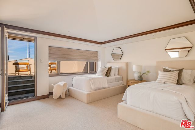 a bed room with two bed and a window