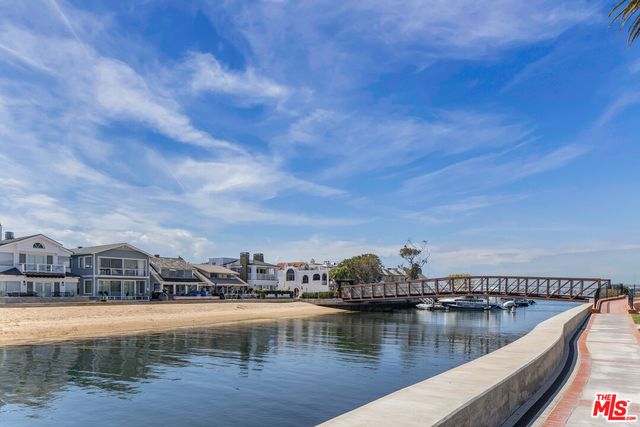 a view of swimming pool with outdoor seating and lake view