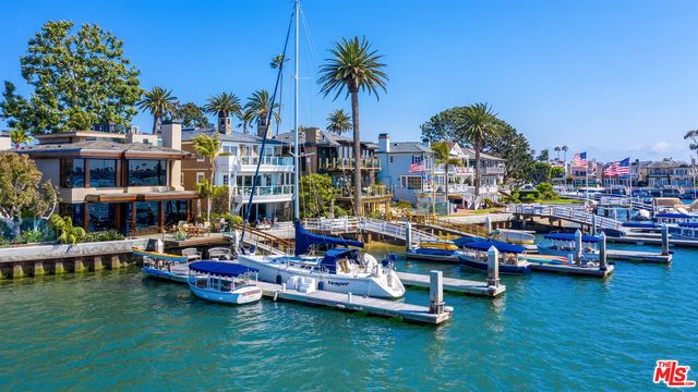 a view of swimming pool with lawn chairs and plants