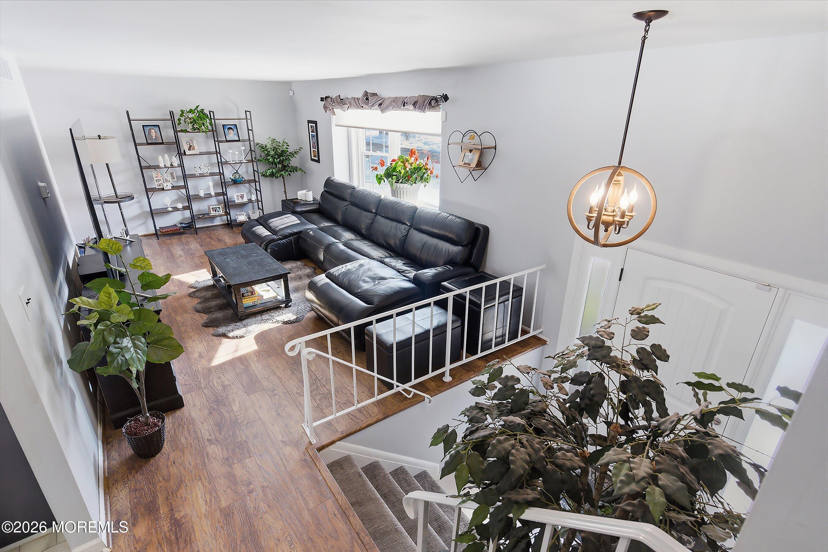 7 Colonial Court Howell, NJ 07731 - Photo 15 of 36 a living room with furniture and a wooden floor