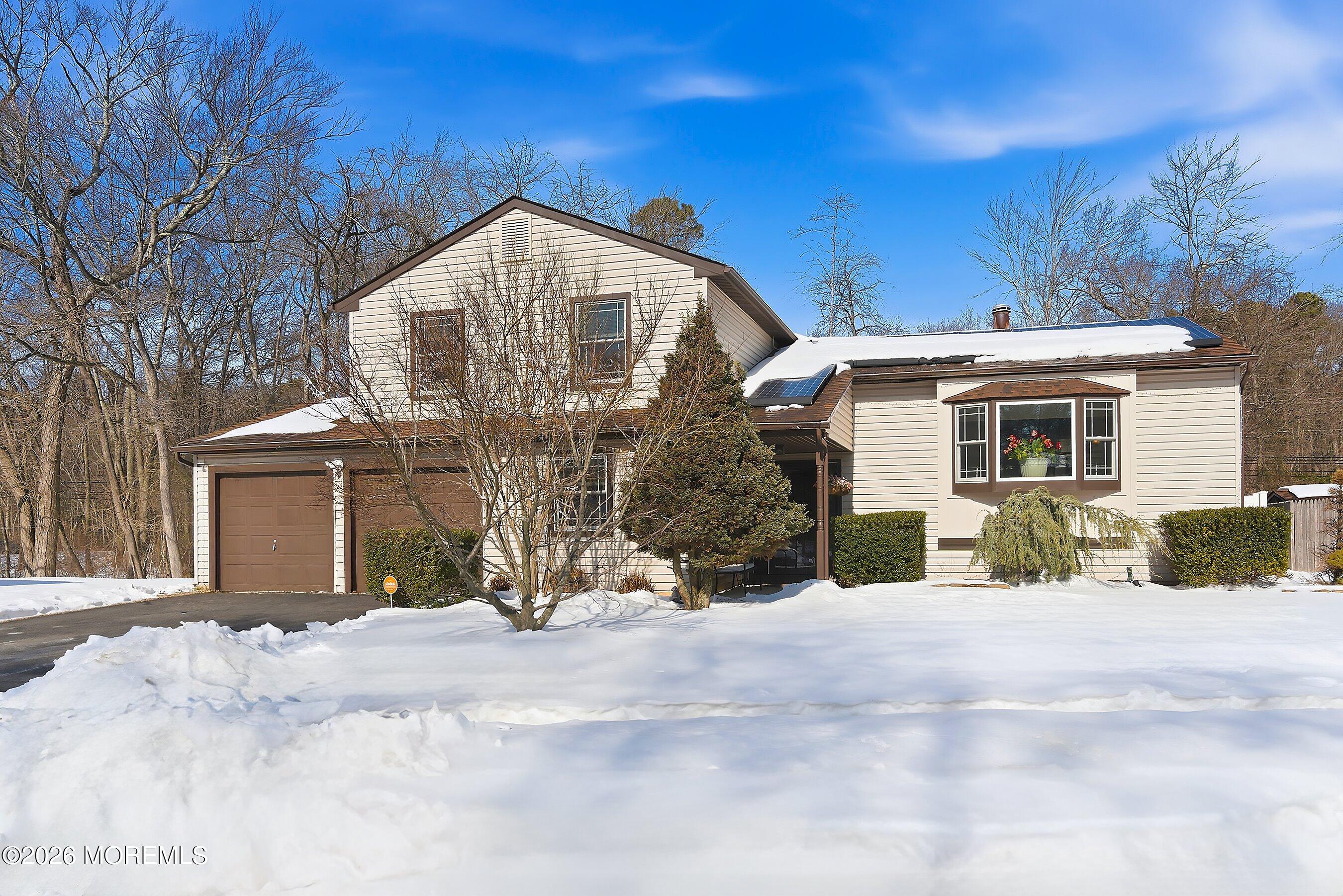 7 Colonial Court Howell, NJ 07731 - Photo 32 of 36 a view of a house with snow on the side of the road
