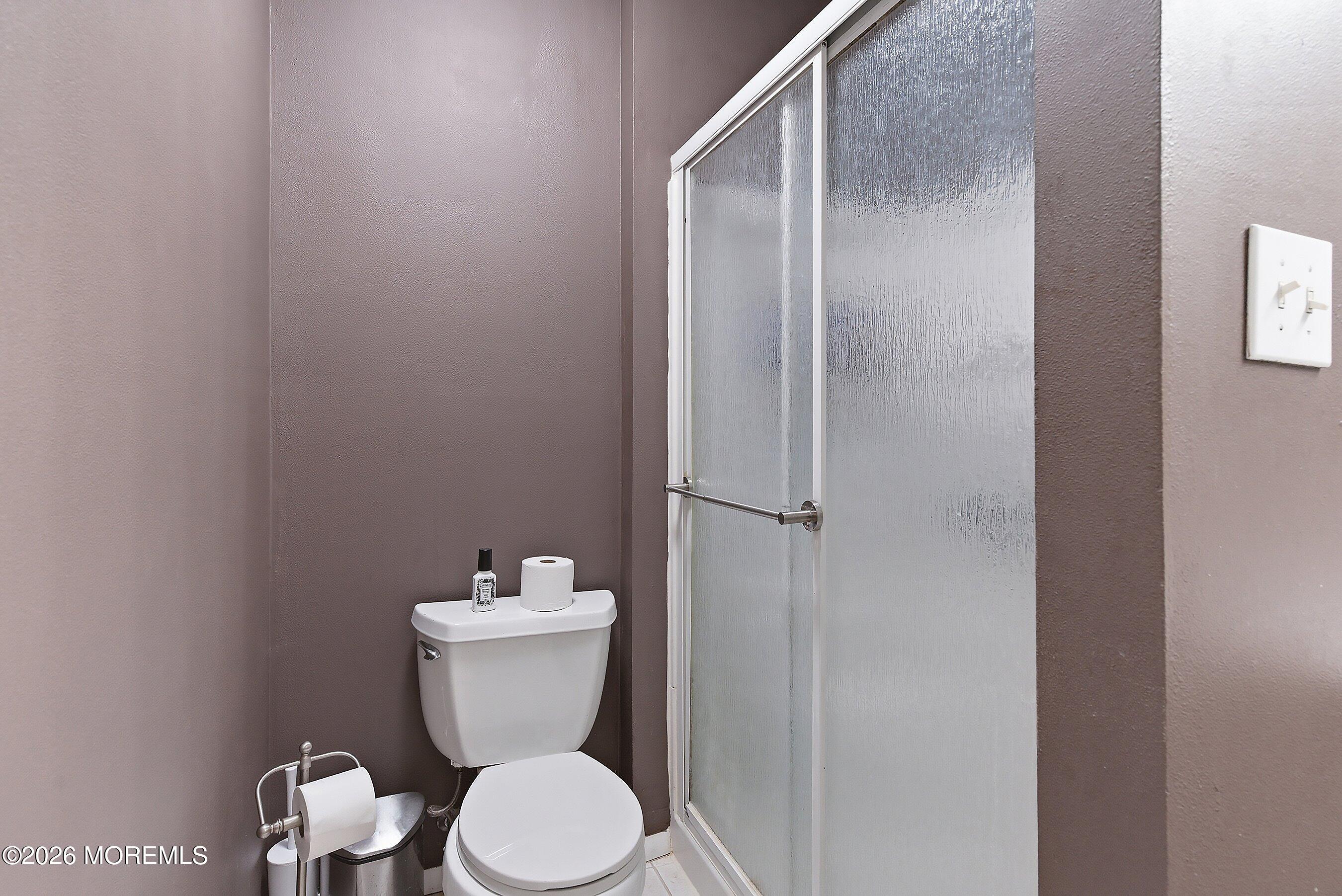 7 Colonial Court Howell, NJ 07731 - Photo 6 of 36 a white toilet sitting next to a bathroom sink