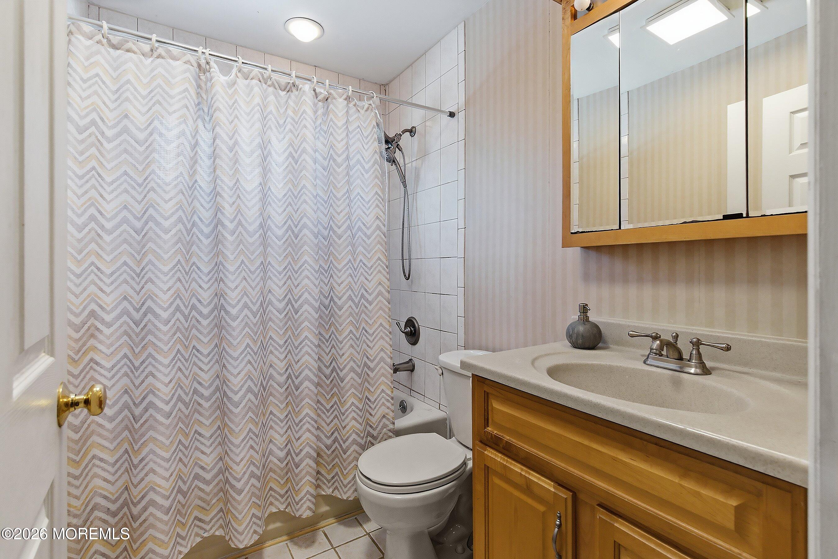 7 Colonial Court Howell, NJ 07731 - Photo 8 of 36 a bathroom with a sink a toilet and shower curtain