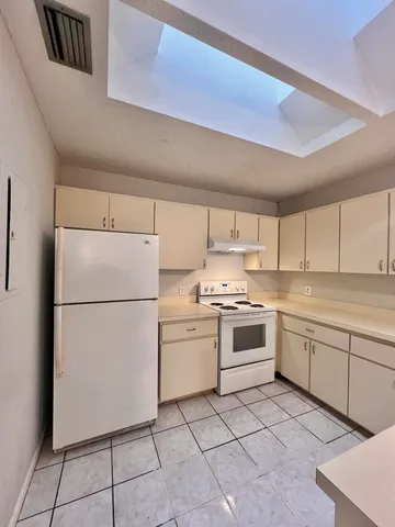 a kitchen with a stove sink and refrigerator
