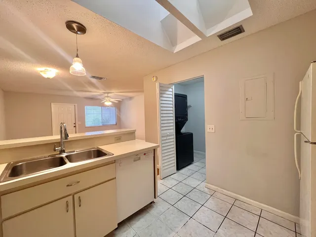 a kitchen with white cabinets and a sink