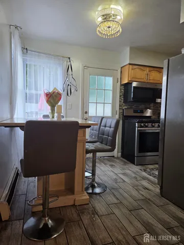 a living room with furniture a desk and chair with wooden floor