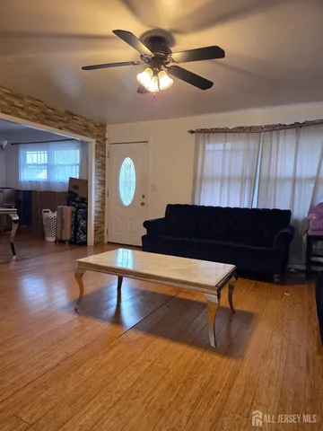 a living room with furniture a fireplace and wooden floor
