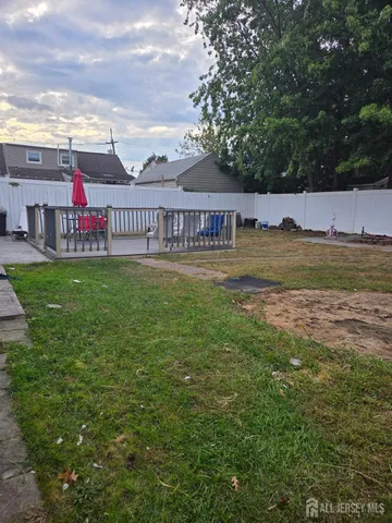 a view of swimming pool with lawn chairs and large trees