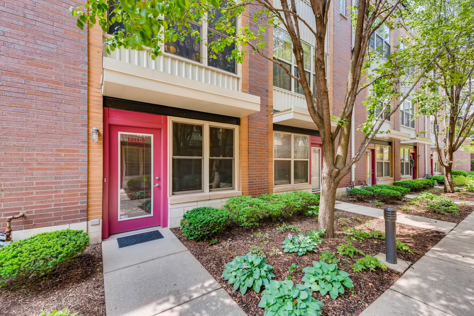 1244 West Monroe Street, Unit 5 Chicago, IL 60607 - Photo 2 of 21 a front view of a house with a garden