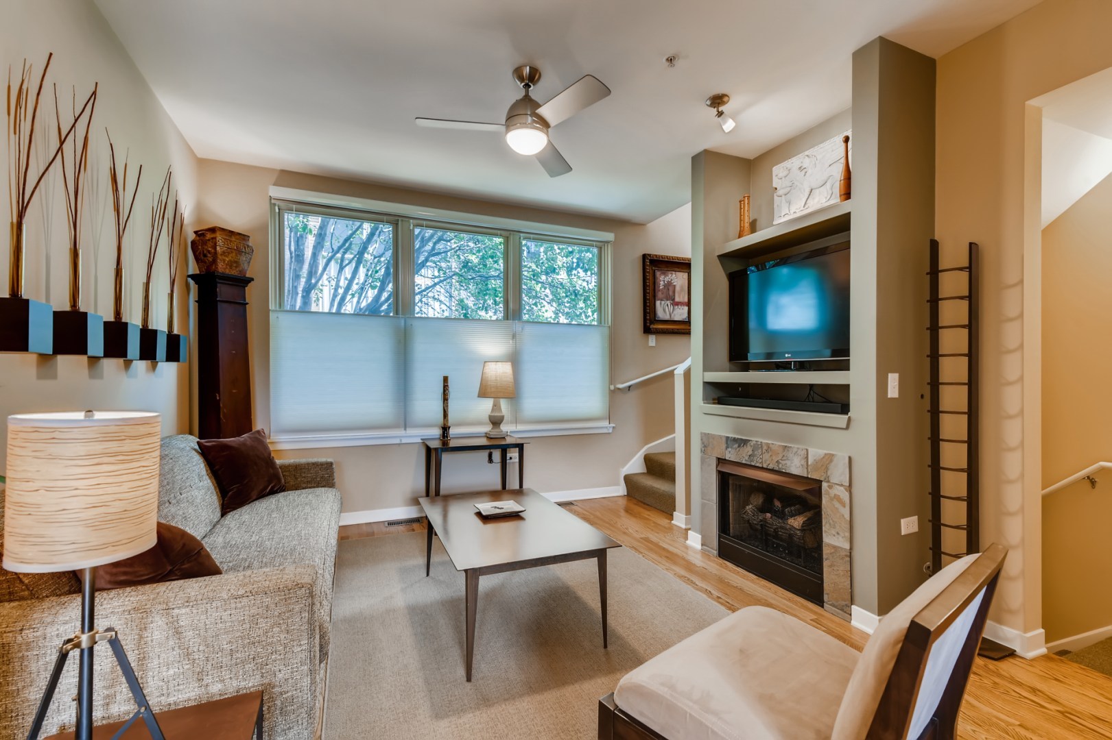 1244 West Monroe Street, Unit 5 Chicago, IL 60607 - Photo 6 of 21 a living room with furniture a flat screen tv and a fireplace