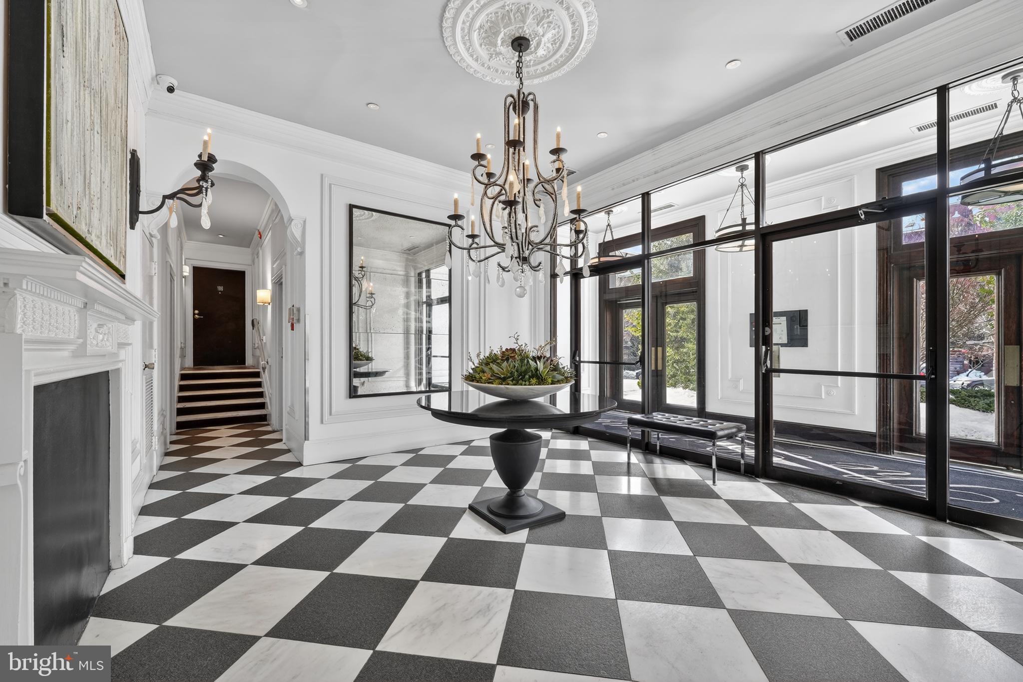 a view of a hallway with a black and white checkered floor