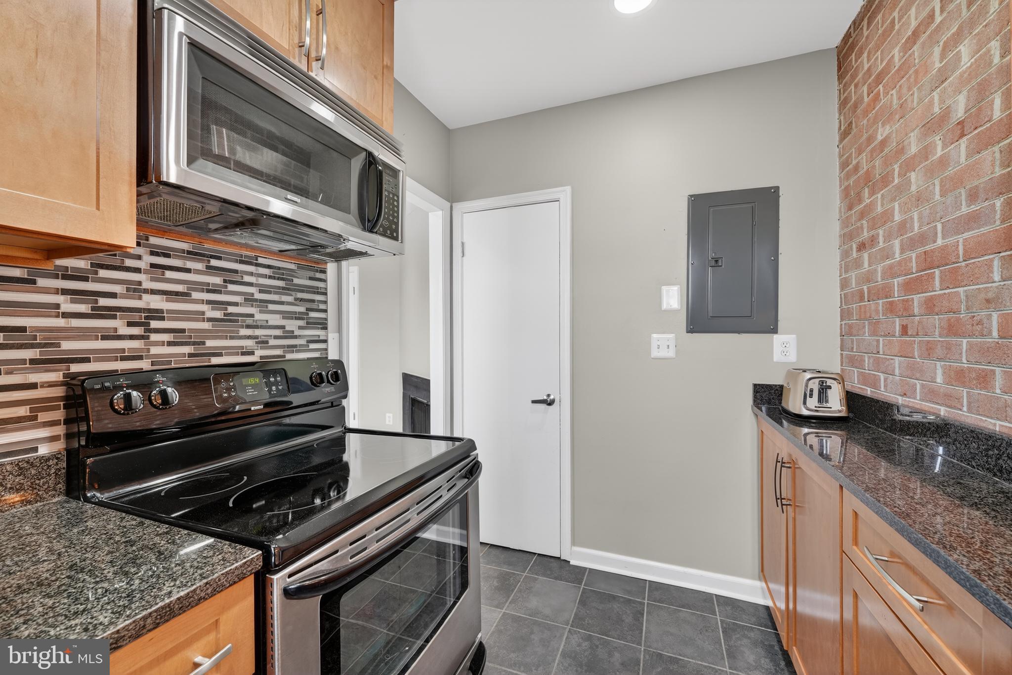 2001 16th Street Northwest, Unit 307 Washington, DC 20009 - Photo 11 of 27 a kitchen with a stove and a microwave