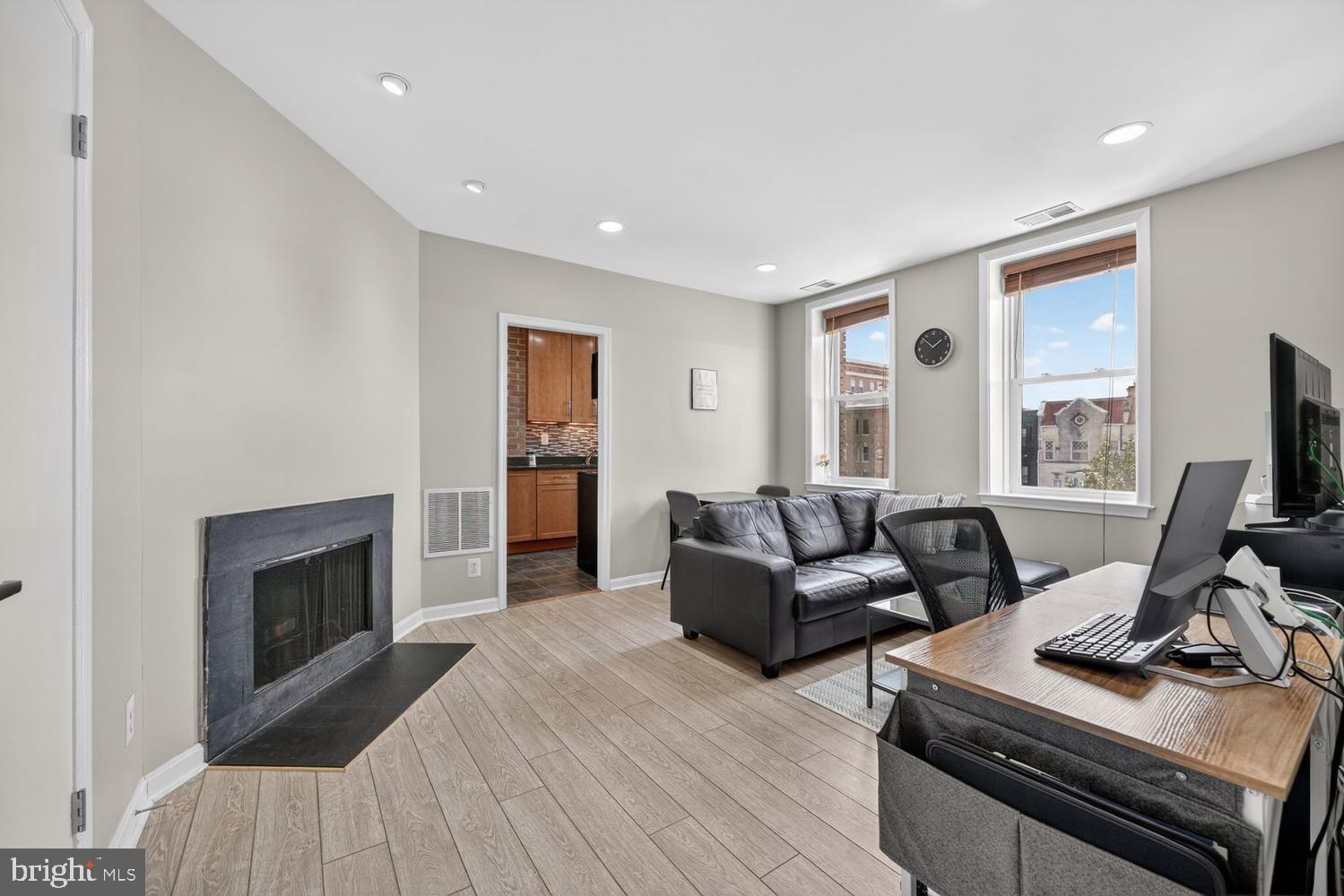 2001 16th Street Northwest, Unit 307 Washington, DC 20009 - Photo 3 of 29 a living room with furniture and a fireplace