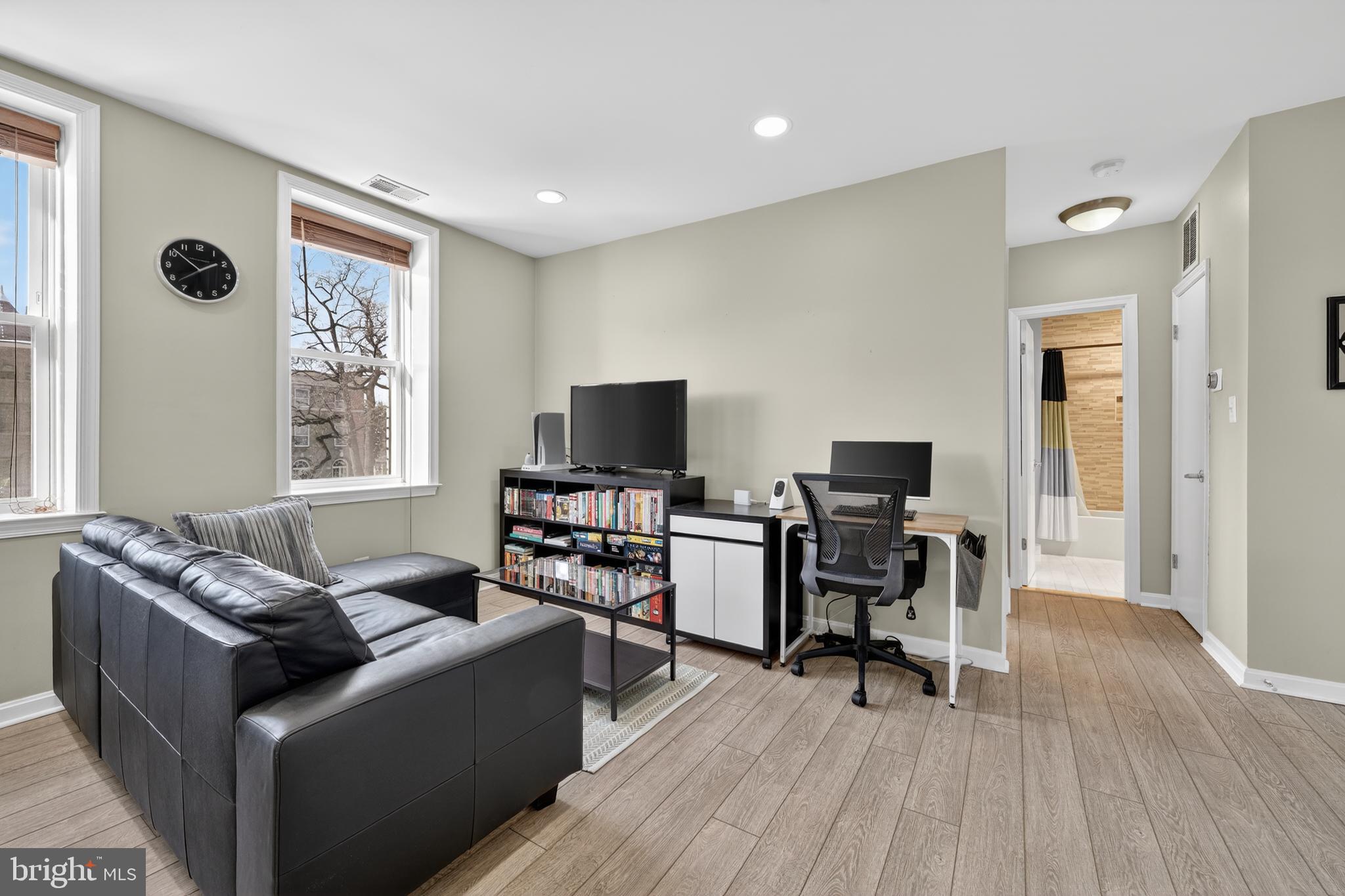 2001 16th Street Northwest, Unit 307 Washington, DC 20009 - Photo 6 of 27 a living room with furniture and a flat screen tv with wooden floor