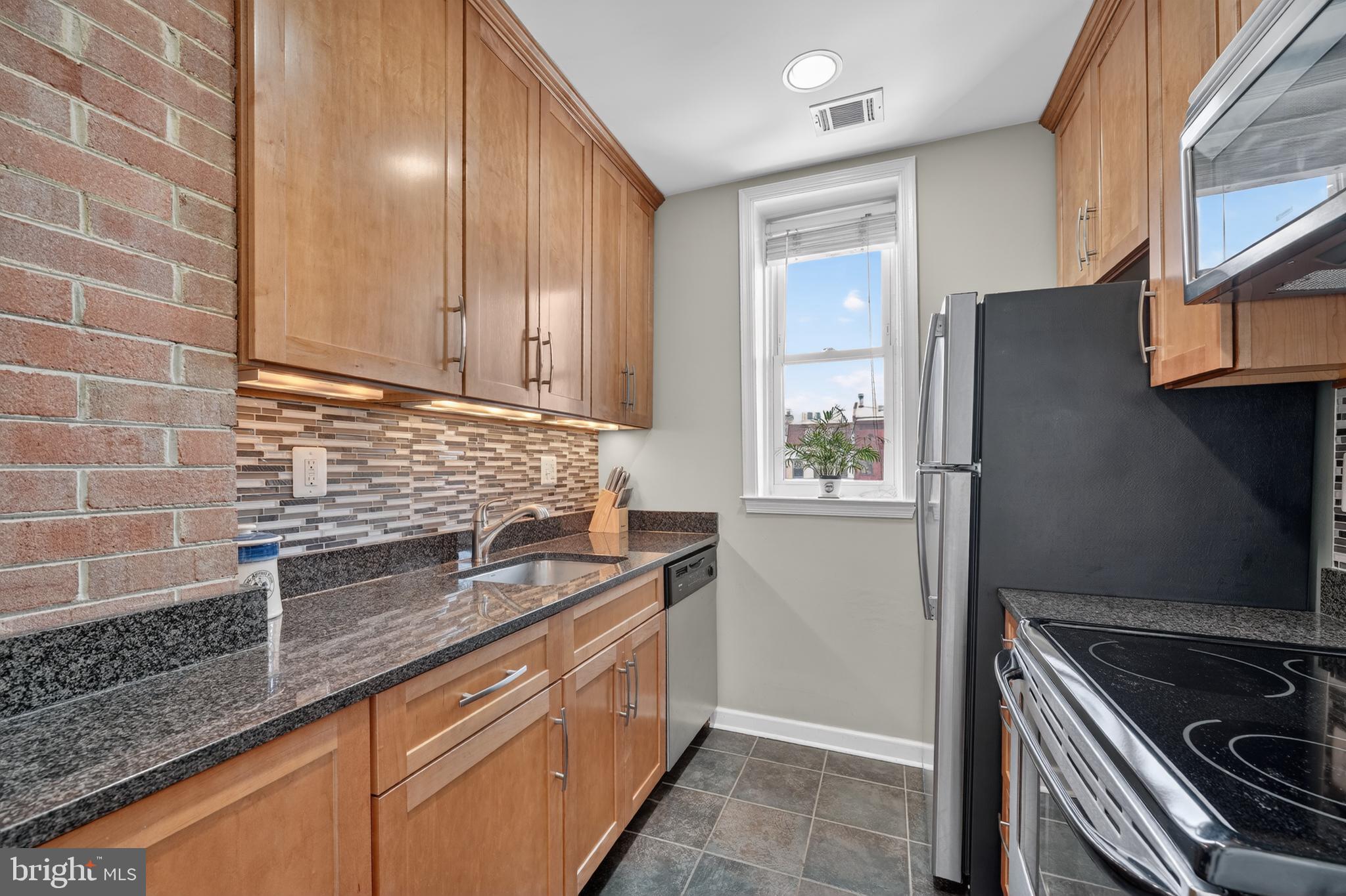 2001 16th Street Northwest, Unit 307 Washington, DC 20009 - Photo 9 of 27 a kitchen that has a sink and a stove