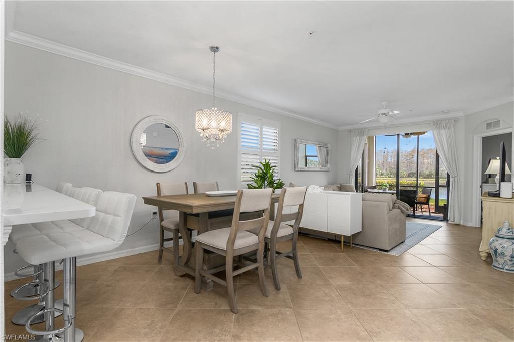 a living room with furniture a window and a clock