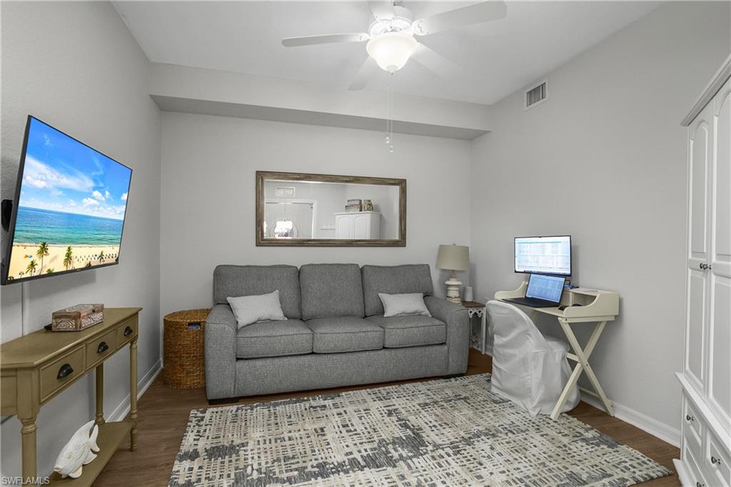 9560 Trevi Court, Unit 4811 Naples, FL 34113 - Photo 16 of 40 a living room with furniture and a flat screen tv