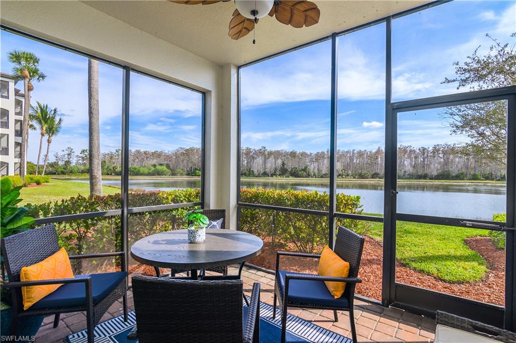 9560 Trevi Court, Unit 4811 Naples, FL 34113 - Photo 18 of 40 a view of a city from a dining room with large windows and outside view