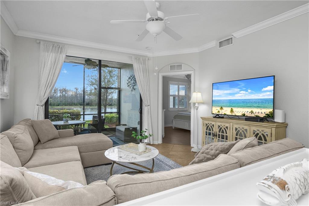 9560 Trevi Court, Unit 4811 Naples, FL 34113 - Photo 2 of 40 a living room with furniture and a flat screen tv