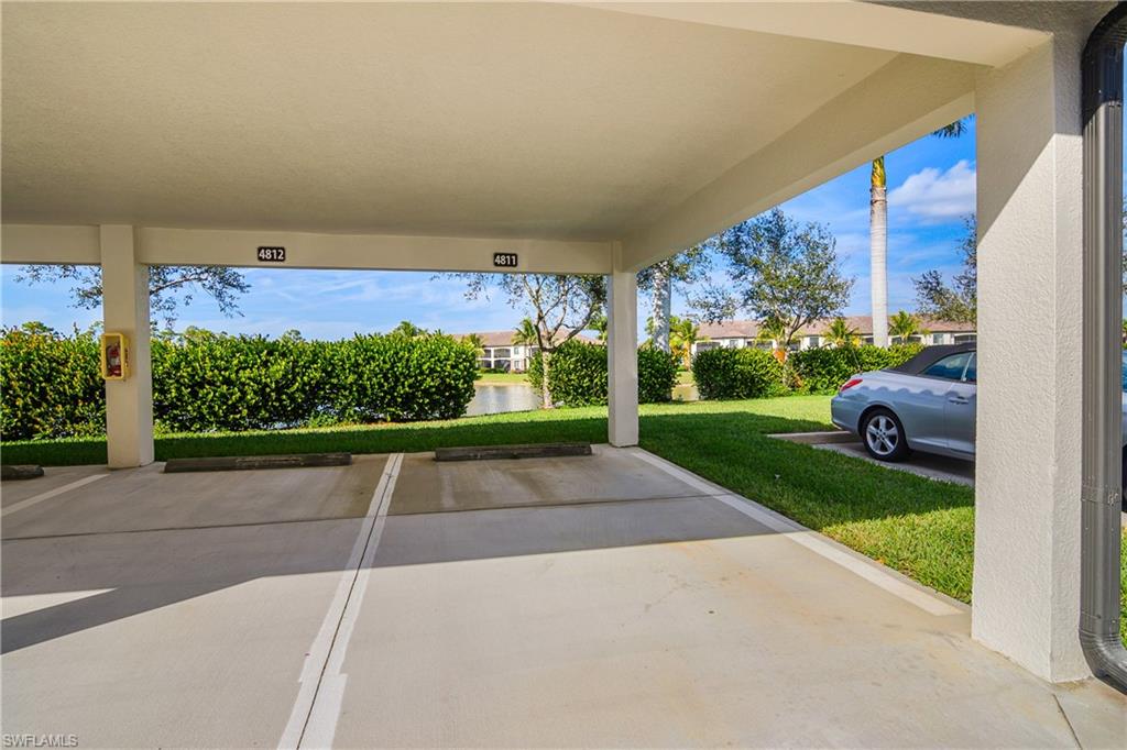 9560 Trevi Court, Unit 4811 Naples, FL 34113 - Photo 21 of 40 a view of yard with car parked