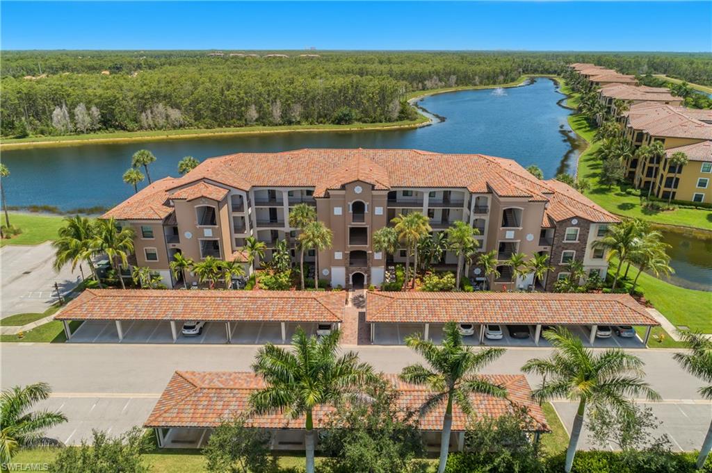 9560 Trevi Court, Unit 4811 Naples, FL 34113 - Photo 22 of 40 an aerial view of a house with a garden and lake view