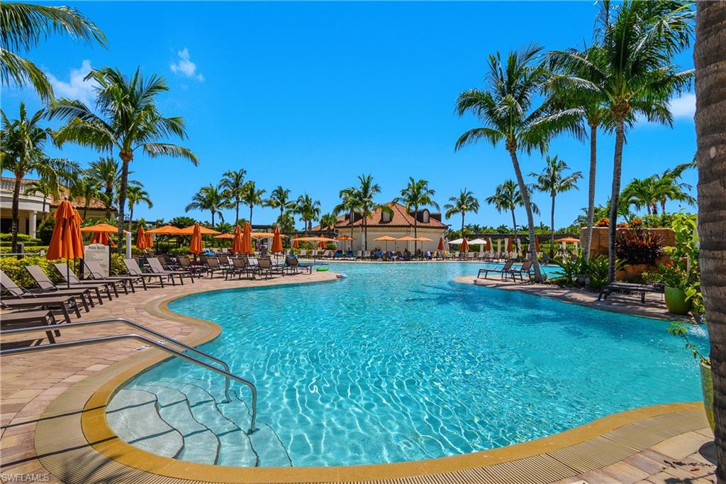 9560 Trevi Court, Unit 4811 Naples, FL 34113 - Photo 27 of 40 a view of a swimming pool with a patio and a yard