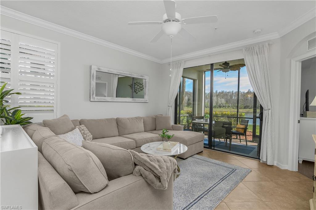 9560 Trevi Court, Unit 4811 Naples, FL 34113 - Photo 3 of 40 a living room with furniture and a large window