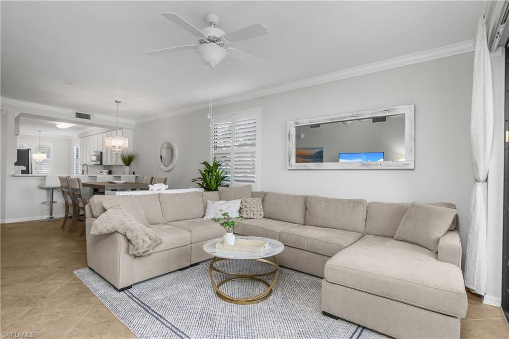 9560 Trevi Court, Unit 4811 Naples, FL 34113 - Photo 4 of 40 a living room with furniture and a large window