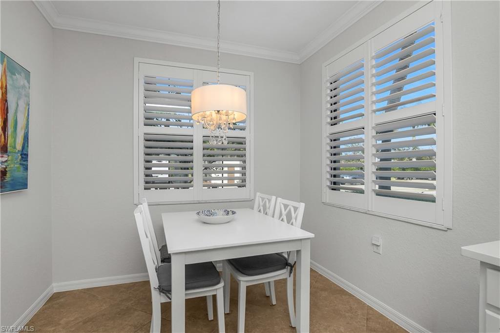 9560 Trevi Court, Unit 4811 Naples, FL 34113 - Photo 10 of 40 a view of a dining room with furniture and window