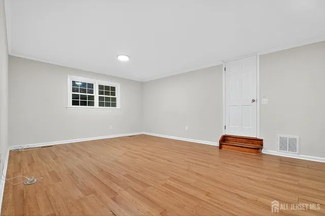a view of room with wooden floor and window