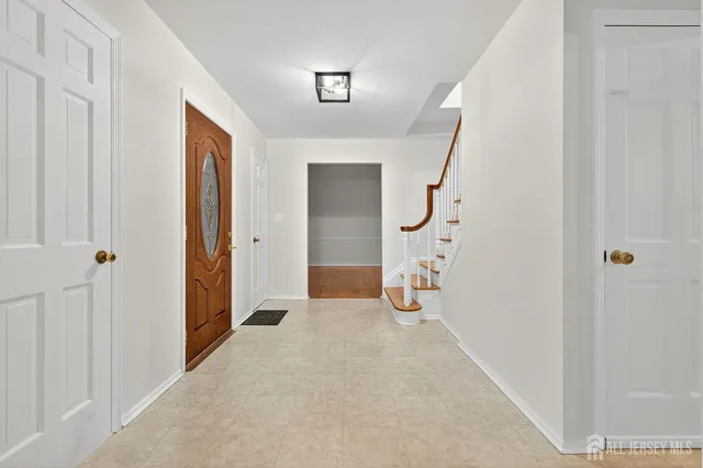 a view of a hallway with wooden floor and entryway