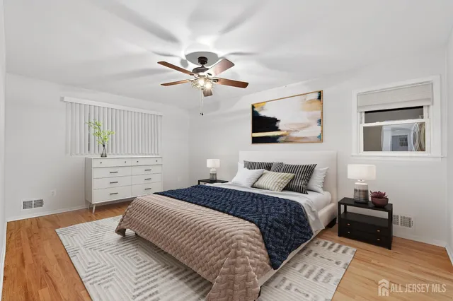 a view of a big room with wooden floor and windows