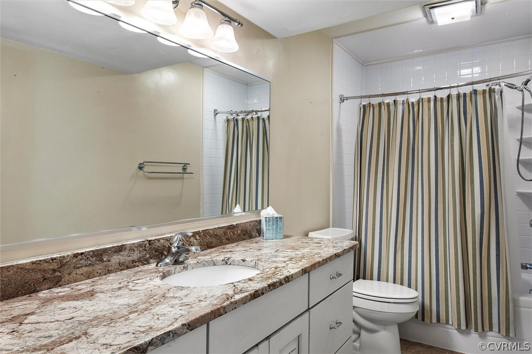 1970 Albion Road Midlothian, VA 23113 - Photo 38 of 50 a bathroom with a granite countertop sink a toilet and mirror