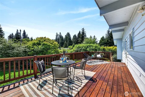 a view of balcony with furniture and wooden floor