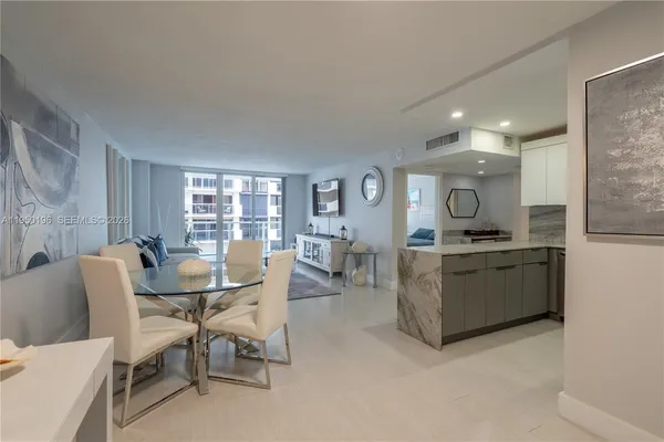 a dining room with furniture and window