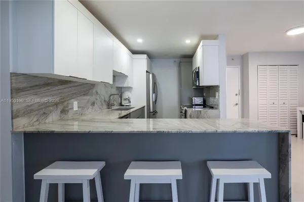 a kitchen with cabinets counter space and appliances