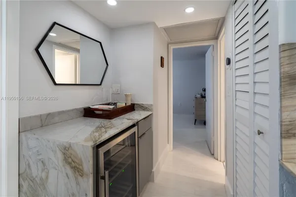 a bathroom with a granite countertop sink a mirror and a shower